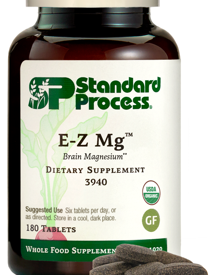Image of E-Z Mg bottle next to tablets of magnesium supplements.